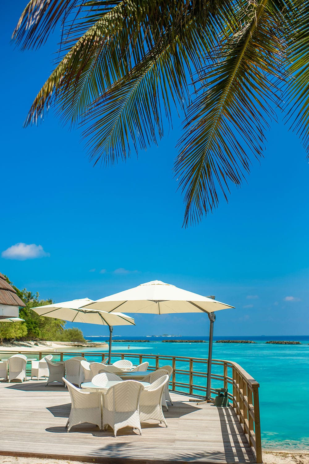 outdoor terrace by the sea at Bandos Maldives