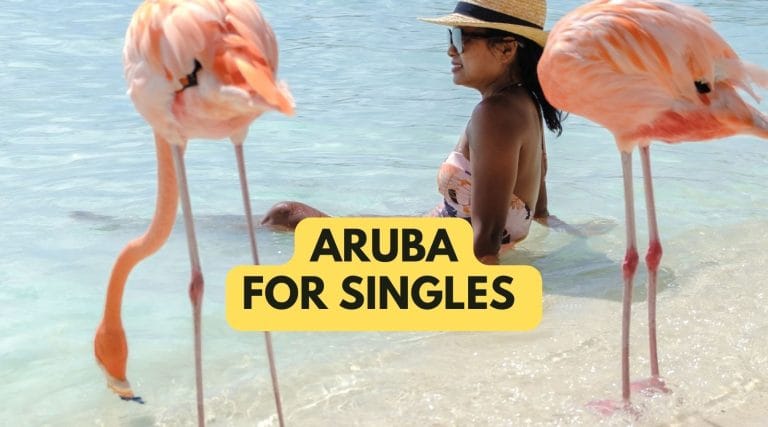 single lady between flamingos on a beach in aruba