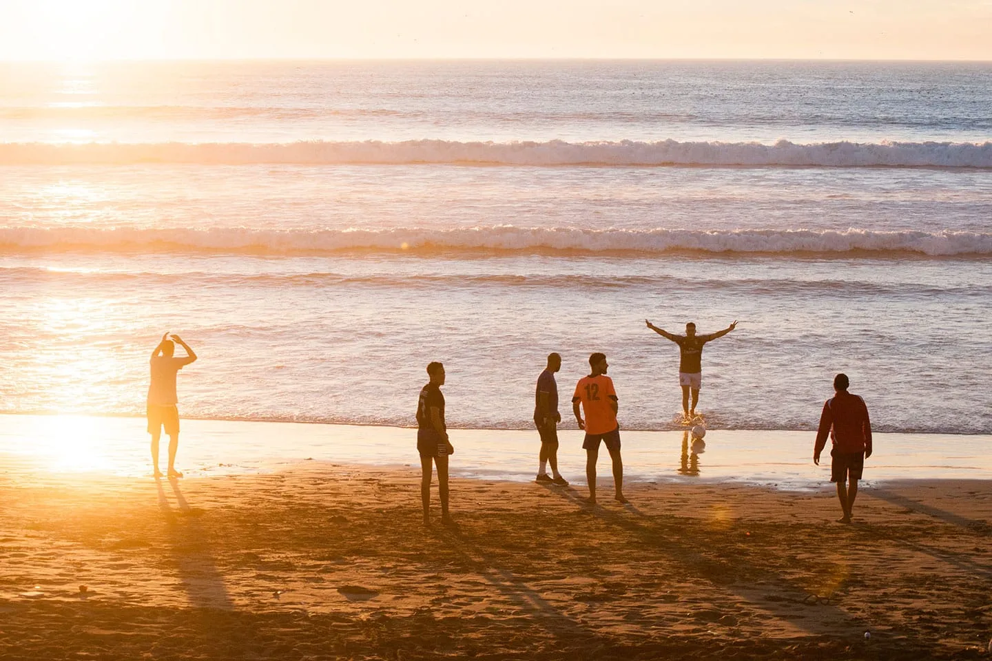People playing footbal at the beach