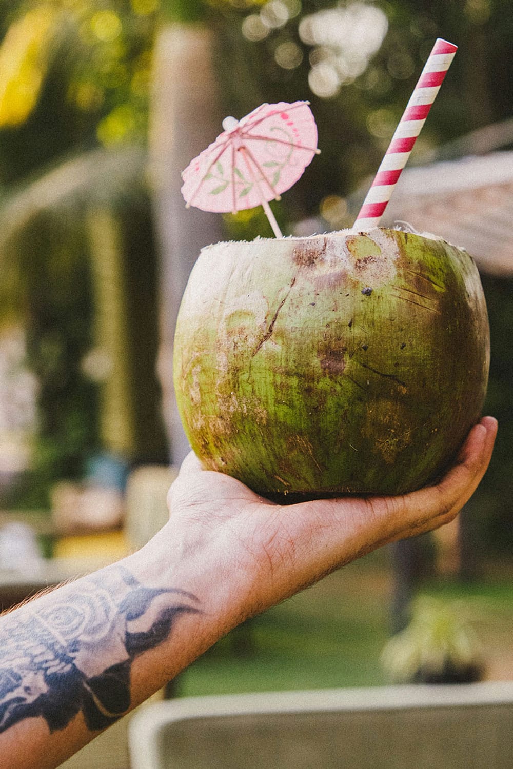 man holding coconut drink