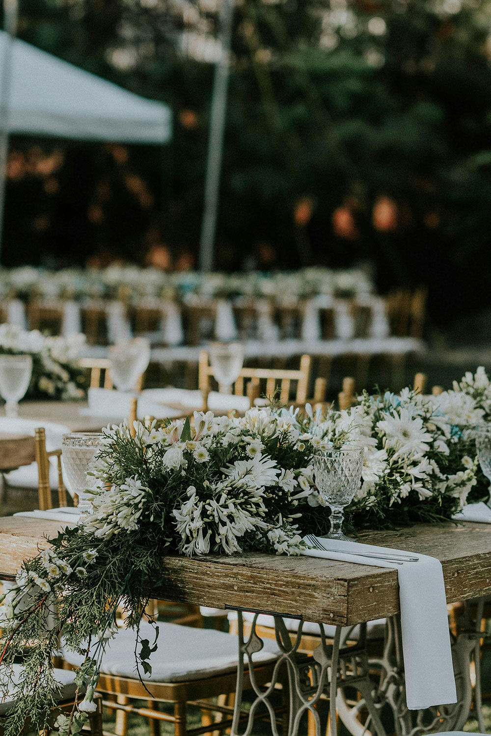 tables with white and green floral garlands