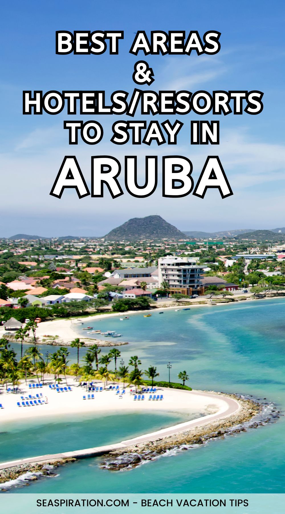 aerial view of Aruba's capital, Oranjestad with small mountain peak in the background and white sand beach in the foreground
