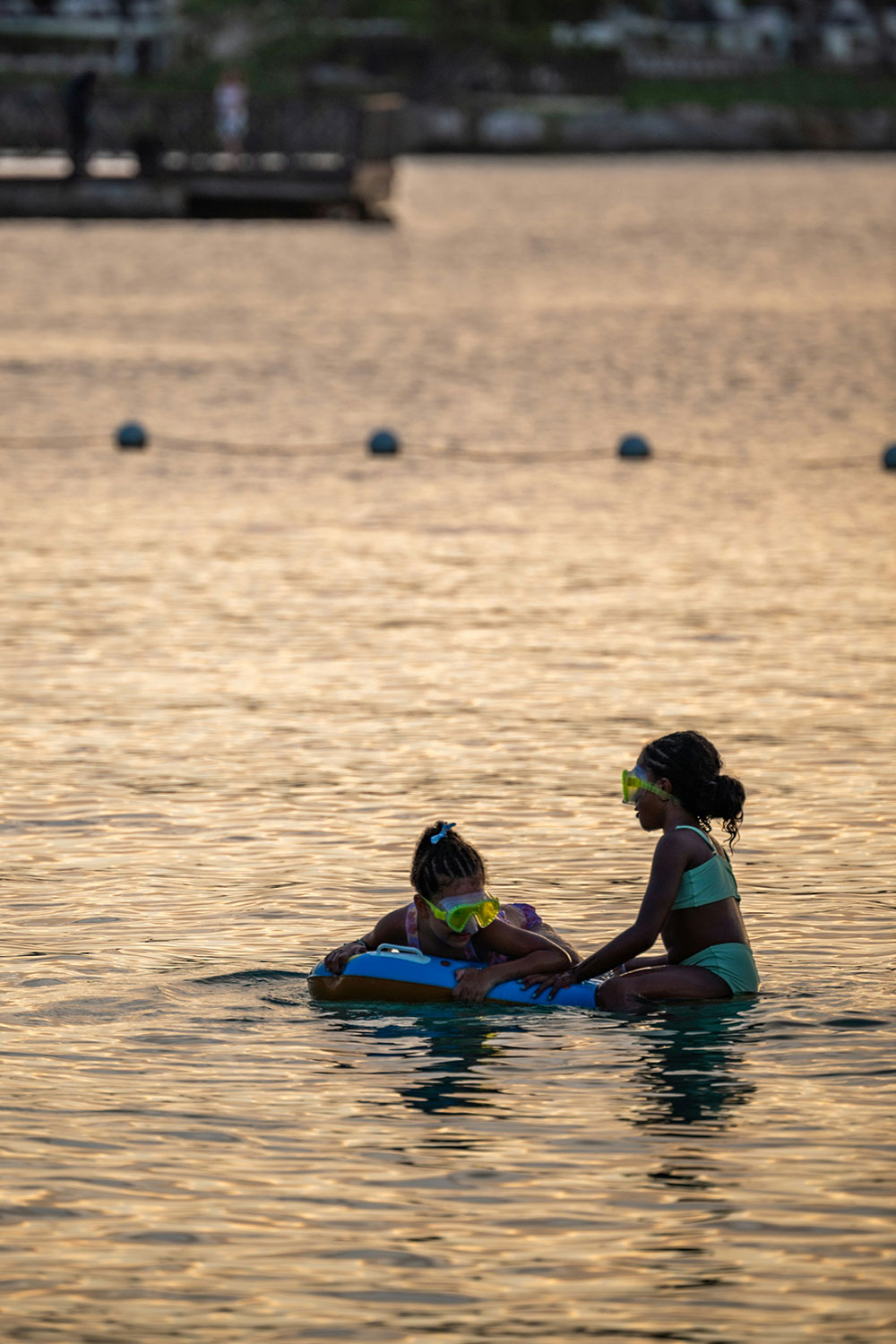 two children using snorkel masks in the sea